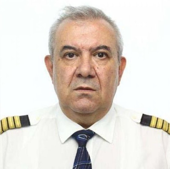 Turkish Airlines pilot İlçehin Pehlivan wears the airline uniform and gives a blank expression