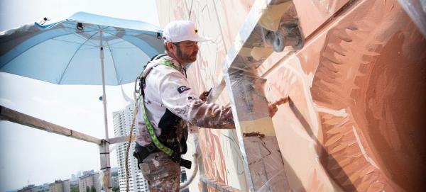 Renowned street artist Fintan Magee of Australia hard at work creating the mural at the Vienna International Centre. Renowned street artist Fintan Magee of Australia hard at work creating the mural at the Vienna International Centre.