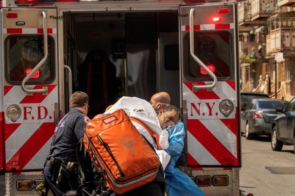 New York City Fire Department (FDNY) and Emergency Medical Technicians (EMT) wearing personal protective equipment lift a man after moving him from a nursing home into an ambulance during an ongoing outbreak of the coronavirus disease (COVID-19) in the Brooklyn borough of New York, U.S., April 16, 2020.