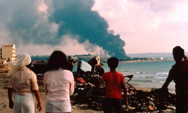 People watch smoke rising into the sky during Israel’s invasion of Lebanon in 1982.