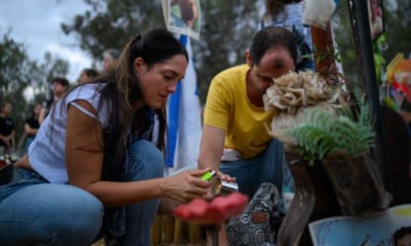Family and friends gather at the Nova festival memorial to mark the first anniversary.